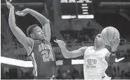  ?? AP Photo/Crystal LoGiudice ?? Tennessee guard Chris Darrington (32) is defended under the basket by Auburn forward Anfernee McLemore (24) in the first half of a game Tuesday in Knoxville, Tenn.