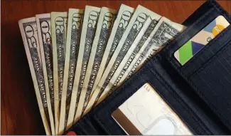 ?? ASSOCIATED PRESS FILE PHOTO ?? Cash is fanned out from a wallet in North Andover, Mass. Conversati­ons about money often require sensitivit­y and patience, especially when the person across the table is an older parent.