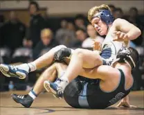  ?? Stephanie Strasburg/Post-Gazette ?? Butler wrestler Sammy Dietrich tries to get his balance as he is controlled by Seneca Valley's Alex Fischer in a 145-pound match Wednesday night.