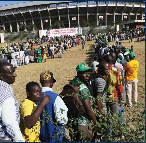  ?? Photograph: AP Photo/Tsvangiray­i Mukwazhi ?? People queued for the inaugurati­on ceremony of Zimbabwean president Emmerson Mnangagwa in Harare. This was the second swearing-in of Mnangagwa in just nine months as a country once jubilant over the fall of long-time leader Robert Mugabe became more subdued after the re-emergence of harassment of the opposition