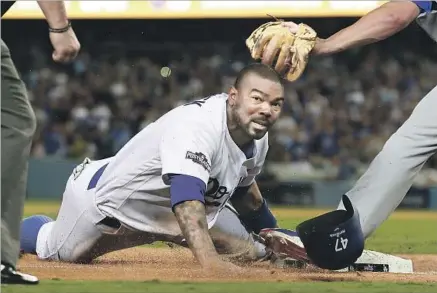  ?? Robert Gauthier Los Angeles Times ?? THE DODGERS’ Howie Kendrick steals third base during the fourth inning against the Cubs in Game 5 of the NLCS.