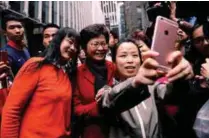  ?? REUTERSPIX ?? People take selfies with Lam a day after she was elected in Hong Kong yesterday.