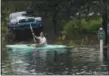  ?? BY KEN BLEVINS/THE STAR-NEWS VIA AP ?? A man paddles through the neighborho­od as Hurricane Florence leaves a trail of flooded roads, broken trees and downed power lines across Leland, N.C.