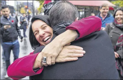  ?? CP PHoTo ?? Montreal’s new mayor Valerie Plante hugs an acquaintan­ce while greeting commuters outside a subway station Monday, November 6, 2017 in Montreal. Plante scored a stunning upset in Montreal’s mayoral election on Sunday, defeating incumbent Denis Coderre...