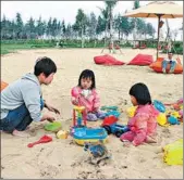  ?? PROVIDED TO CHINA DAILY ?? Twin daughters and their mother enjoy a smog-free holiday in Sanya, Hainan province.