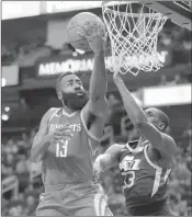  ?? Michael Wyke ?? The Associated Press Rockets guard James Harden soars to the basket against Jazz center Ekpe Udoh in the first half of Houston’s 137-100 win Sunday at the Toyota Center.