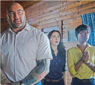  ?? UNIVERSAL PICTURES VIA AP ?? From left, Dave Bautista, Abby Quinn and Nikki Amuka-Bird appear in “Knock at the Cabin.”