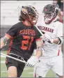  ?? Dave Stewart / Hearst Connecticu­t Media ?? Ridgefield’s Joe deGrasse (21) battles New Canaan’s Chris Canet (2) at Dunning Field in New Canaan on Saturday.