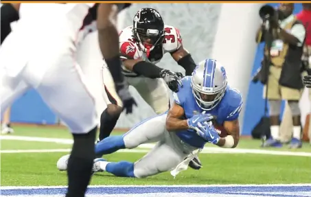  ?? | REY DEL RIO/ GETTY IMAGES ?? Lions receiver Golden Tate is touched down at the 1- yard line by Falcons cornerback Brian Poole on the final play.