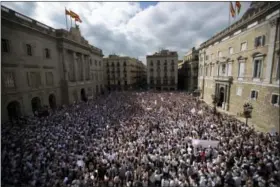  ?? EMILIO MORENATTI — THE ASSOCIATED PRESS ?? People gather during a protest in favor of talks and dialogue in Sant Jaume square in Barcelona, Spain, Saturday.