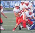  ?? TIM PHILLIS — FOR THE NEWS-HERALD ?? Mentor’s Riley Coughlin picks up yards against Brunswick on Sept. 18.