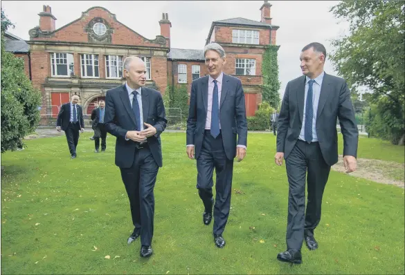  ?? PICTURE JAMES HARDISTY. ?? TAKING STEPS: Chancellor Philip Hammond visits a new developmen­t at Seacroft Hospital, Leeds, with Tom Riordan of Leeds City Council, and Nick Walkley of the Homes and Communitie­s Agency.