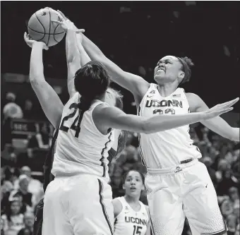  ?? SEAN D. ELLIOT/THE DAY ?? UConn’s Napheesa Collier (24) and Azura Stevens combine to block a shot by South Florida’s Alyssa Rader during the first half of the Huskies’ 82-53 win over South Florida on Monday night in Storrs.