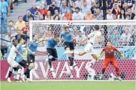  ?? DAVID VINCENT/ASSOCIATED PRESS ?? France’s Raphael Varano, second from right, scores his side’s first goal during a quarterfin­al victory over Uruguay.