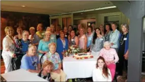  ??  ?? Current TVGC members and guests surround their Happy 90th Anniversar­y Strawberry Cake created by member Sheila McFadden of Malvern and her daughter for the club luncheon celebratio­n.