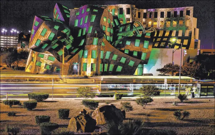  ?? L.E. Baskow Las Vegas Review-Journal @Left_Eye_Images ?? The windows are bathed in green from within the Keep Memory Alive Event Center at the Cleveland Clinic Lou Ruvo Center for Brain Health. The center was designed by renowned architect Frank Gehry.