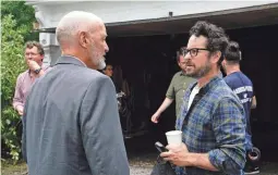  ??  ?? “Castle Rock” executive producer J.J. Abrams visits with his “Lost” star Terry O’Quinn, who plays Shawshank warden Dale Lacy in the new Hulu series.