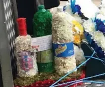  ??  ?? Poor taste? Flower-decked vodka and lemonade bottles. It was said to be Vincent’s favourite drink