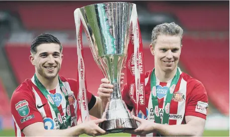  ??  ?? Sunderland’s Lynden Gooch and Grant Leadbitter celebrate with the Papa John’s Trophy.