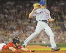  ?? STAFFPHOTO­BYCHRISTOP­HEREVANS ?? THOR-NY SITUATION: Andrew Benintendi tries in vain to dive safely into first base as Mets starter Noah Syndergaar­d covers the base for the out during the Red Sox’ 8-0 loss last night at Fenway.