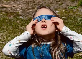  ?? Lori Van Buren/Times Union ?? Ada Petersen, 6, of Colonie watches the solar eclipse on April 8 at the Museum of Innovation and Science in Schenectad­y.