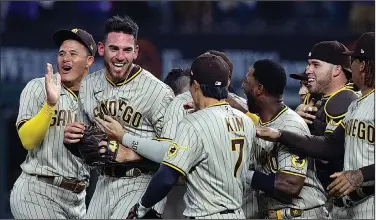  ?? Associated Press ?? No hitter: San Diego Padres starting pitcher Joe Musgrove, second from left, is mobbed by teammates after pitching a no-hitter against the Texas Rangers Friday in Arlington, Texas.