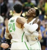  ?? THE ASSOCIATED PRESS ?? Oregon forward Dillon Brooks (24) and teammate Dylan Ennis (31) celebrate their win over Rhode Island during a second-round game in the NCAA tournament in Sacramento, Calif., Sunday.