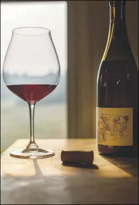  ??  ?? A glass of pinot noir bottled at Big Table Farm is shown Sept. 5 in Gaston, Ore. A decade after acquiring 70 acres here in the hills of the northern Willamette Valley, proprietor­s Brian Marcy and Clare Carver have stitched together a do-it-yourself...