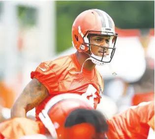  ?? The Associated Press ?? ■ Cleveland Browns quarterbac­k Deshaun Watson stretches during the team’s training camp Monday in Berea, Ohio. Watson was suspended for six games on Monday after being accused by two dozen women in Texas of sexual misconduct during massage treatments, in what a disciplina­ry officer said was behavior “more egregious than any before reviewed by the NFL.”