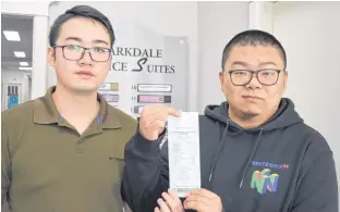  ?? DAVE STEWART/THE GUARDIAN ?? Mark Ma, left, and Blake Zhang were upset that they were identified as “Asian guys’’ on their receipt from Crafters Burger Company in Charlottet­own. The manager has apologized to the men and has vowed to remove any references on the receipts that might be considered offensive.