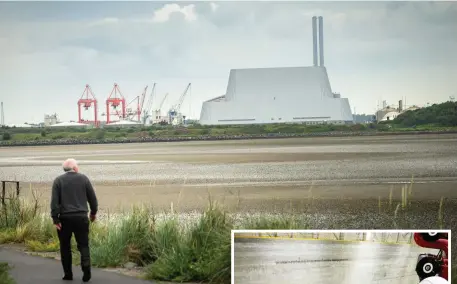  ??  ?? The Dublin Waste to Energy incinerato­r seen across Sandymount Strand. Right, workers watch waste material being unloaded at the facility. Photos: Doug O’Connor and Conor McCabe