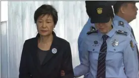  ??  ?? In this Oct. 10, 2017, file photo, former South Korean President Park Geun-hye (left) arrives to attend a hearing on the extension of her detention at the Seoul Central District Court in Seoul, South Korea. A South Korea court is set to issue a verdict...