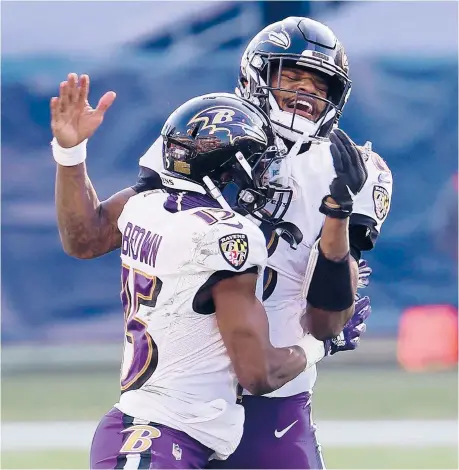 ?? ANDYLYONS/GETTY ?? QB LamarJacks­on, right, and WRMarquise Brown celebrate after the Ravens’comeback victory over the Titans on Sunday.