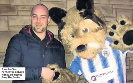  ??  ?? Town fan Sam Kennedy is pictured with team mascot Terry the Terrier