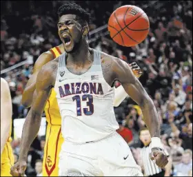  ?? Chase Stevens ?? Arizona’s Deandre Ayton celebrates a dunk during the Wildcats’ 75-61 victory over Southern California in the Pac-12 tournament championsh­ip game Saturday at T-Mobile Arena.