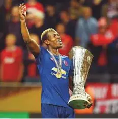  ?? AFP ?? Manchester United’s midfielder Paul Pogba celebrates with the trophy after the Europa League final on Wednesday.