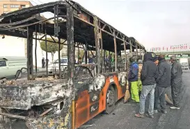  ?? (AFP) ?? The wreckage of a bus that was set ablaze by protesters during a demonstrat­ion in Isfahan on Sunday