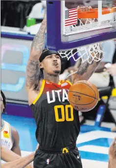  ?? Sue Ogrocki The Associated Press ?? Jazz guard Jordan Clarkson dunks during the first half against the Thunder Monday night in Oklahoma City.