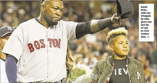  ?? AP ?? David Ortiz, with son D’Angelo by side, gives one last tip of cap to rival Yankee fans.