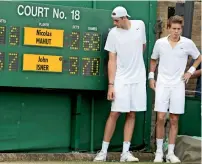  ?? — AP file ?? John Isner and Nicolas Mahut (right) posing for a photo next to the scoreboard following their record-breaking singles match at Wimbledon on June 24, 2010.