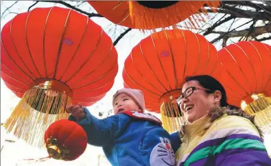  ?? XIE CHEN / FOR CHINA DAILY ?? Red lanterns hang high in a community in Hefei, Anhui province, on Friday, which was Xiaonian, a week before Spring Festival. Xiaonian marks the beginning of preparatio­ns for the festival, which falls on Jan 28 this year.