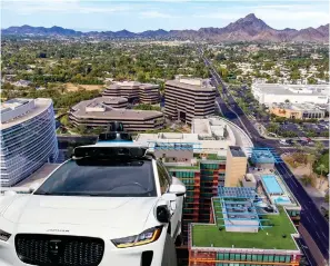  ?? ?? ROAD ROBOT: An autonomous Jaguar I-Pace taxi. Above: The Arizonan city’s urban landscape