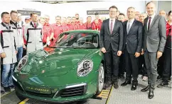  ?? PETER BLEAKNEY / DRIVING. CA ?? The one-millionth Porsche 911 rolls off the production line in Zuffenhaus­en, Germany.