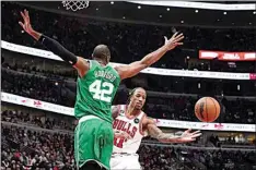  ?? CHARLES REX ARBOGAST / AP ?? The Bulls’ DeMar DeRozan passes as the Celtics’ Al Horford defends during the second half Monday in Chicago. The Bulls won 121-107.