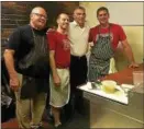  ??  ?? Employees of DeFazio’s Pizzeria pose for a photo with former New York Yankees player and manager Joe Girardi, second from right, during a visit to the Troy pizza shop Wednesday
