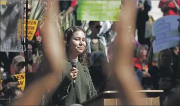  ?? Myung J. Chun Los Angeles Times ?? NALLELI COBO, who has testified at government hearings and co-founded a group that sued Los Angeles over oil drilling in urban neighborho­ods, speaks during a climate change protest Friday at L.A. City Hall.