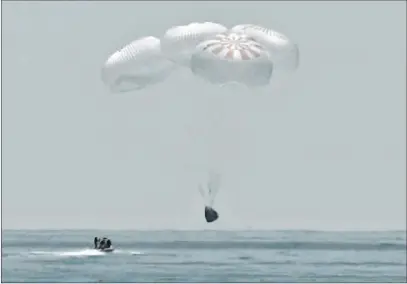  ?? NASA TV ?? The Spacex capsule splashes down in the Gulf of Mexico on Sunday, bringing astronauts Doug Hurley and Bob Behnken back from a two-month mission to the Internatio­nal Space Station. It was the first time a private company has ferried people from orbit.