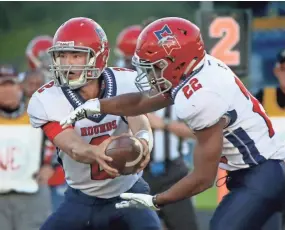  ?? C.T. KRUGER/NOW NEWS GROUP ?? Messmer/Shorewood's Aaron Eimers fakes a handoff to Zoe McDowell at New Berlin West on Aug. 31.