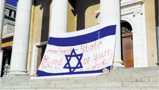  ?? (Facebook) ?? A BLOODIED Israeli flag hangs on the main building at the University of Cape Town on Monday at the start of Israel-Apartheid Week.