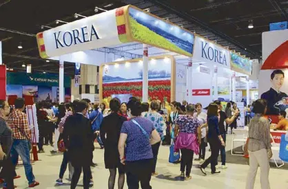  ??  ?? A colorful Korean Tourism Pavilion entices travel expo visitors.